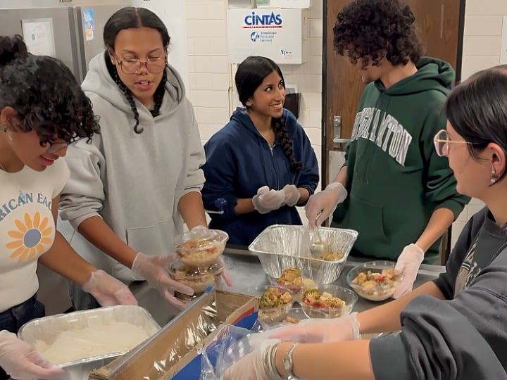 Students in Binghamton University’s Food Recovery Network prepare meals for donation in a campus kitchen.
