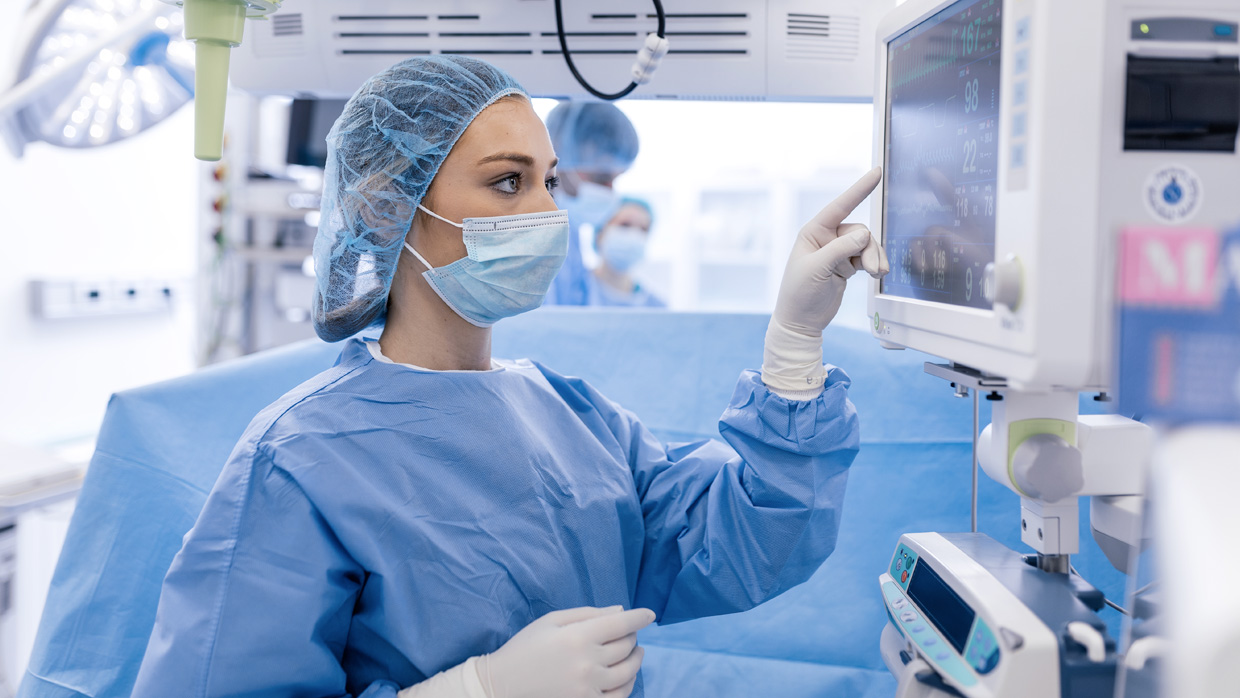 a nurse looking at a screen