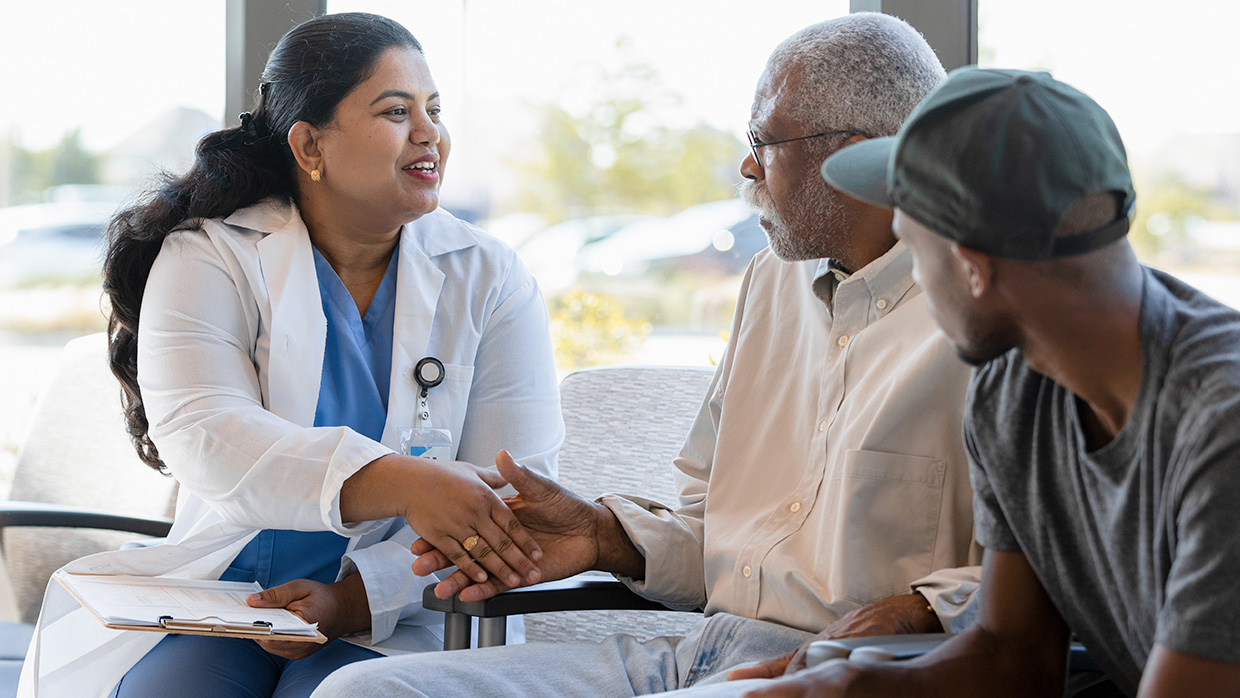 a doctor telling something to an old man
