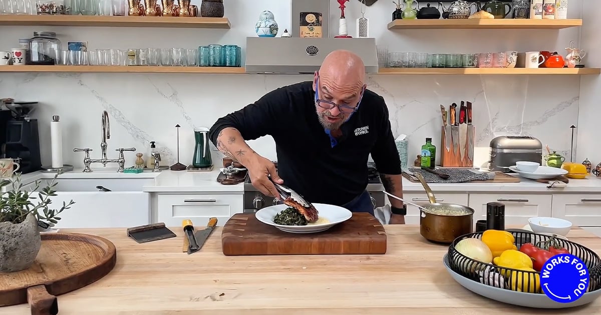 A chef plating a dish in a sleek kitchen, surrounded by utensils, ingredients, and cookware on countertops and shelves.