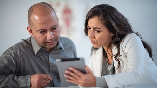 Registered dietitian and patient reviewing a nutrition plan together on a tablet.  