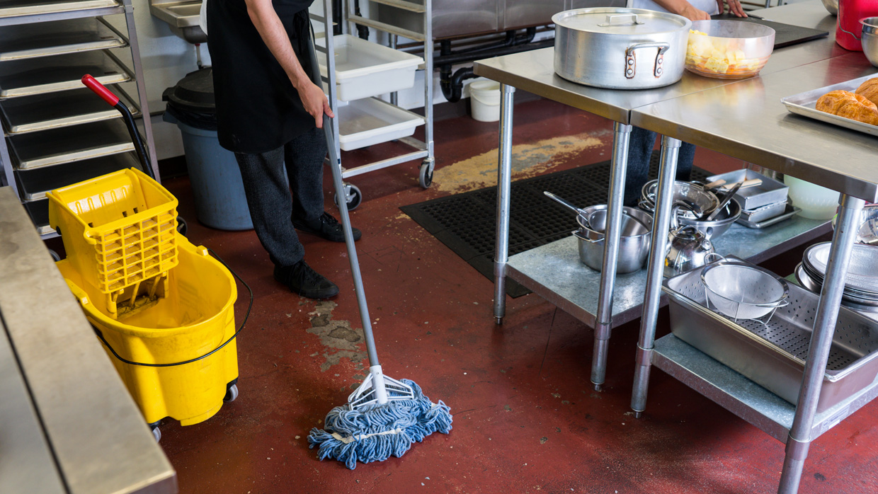 person cleaning a kitchen