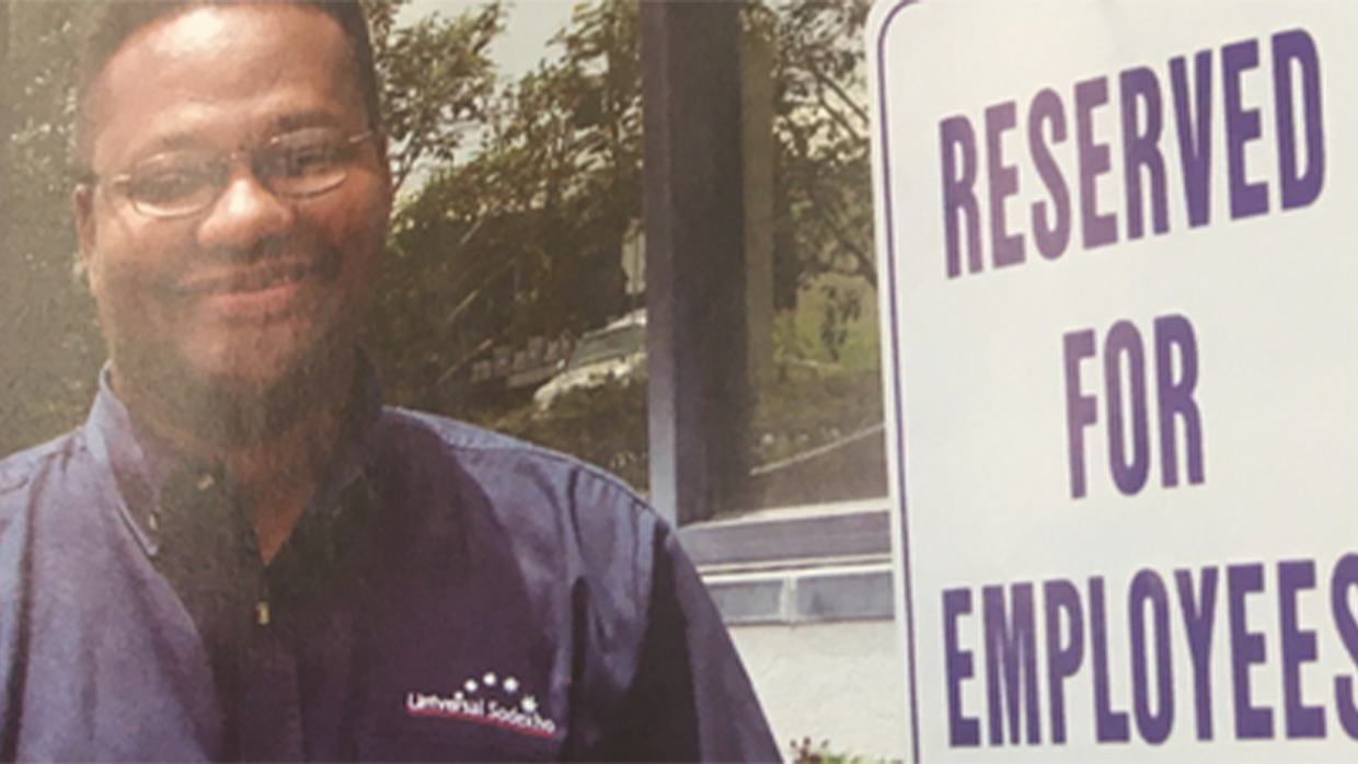 man standing near a sign reserved for employees