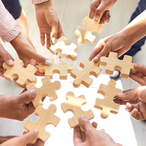 people finishing a puzzle