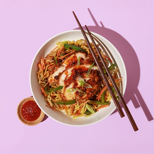 The Crave Experience: Huli Huli chicken over noodles with shredded vegetables and sauce.  