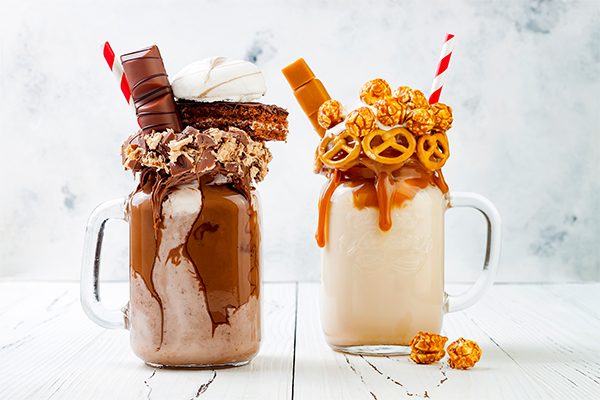 Milkshakes with extravagant toppings including chocolate, caramel popcorn and pretzels