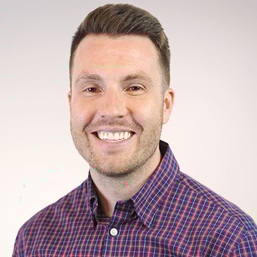 young blonde haired man smiling headshot photo