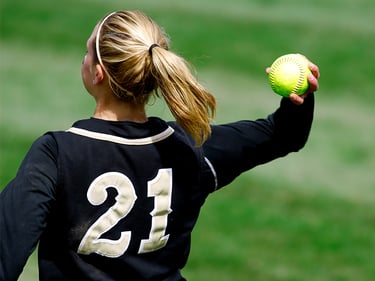 Blond girl with tennis ball in the hand
