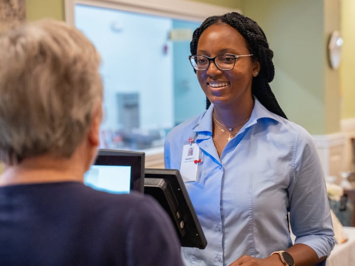 Service attendant warmly greeting a resident.