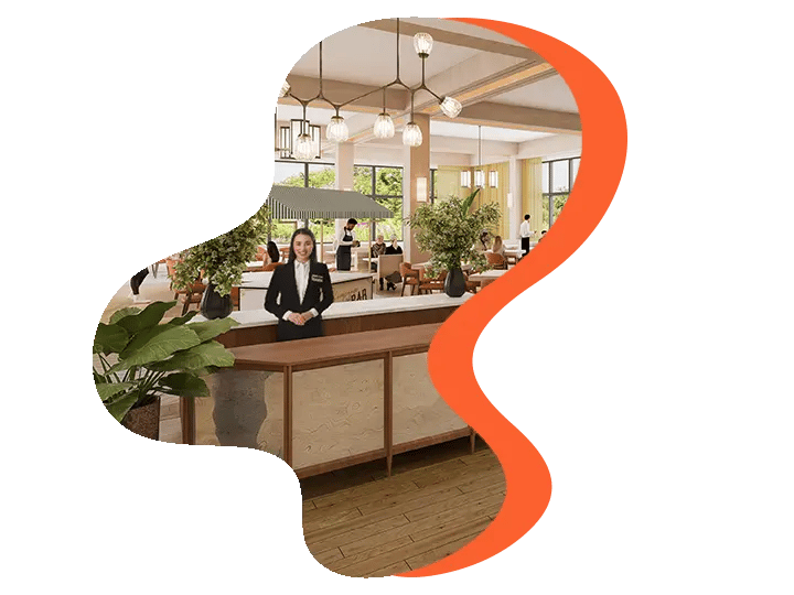 Hotel reception with staff behind desk, surrounded by plants and modern decor.