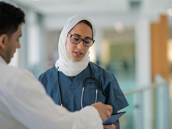 nurse talking to doctor