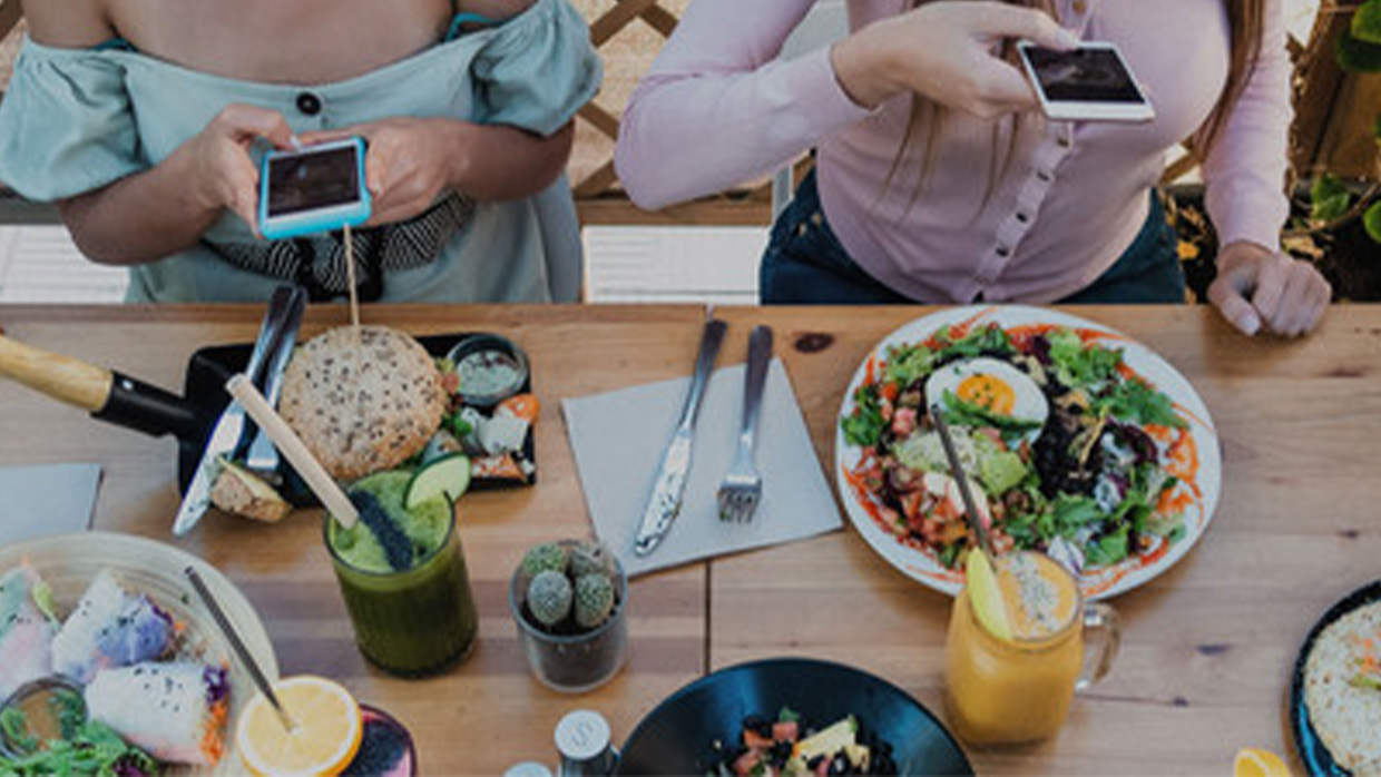 people taking picture to some food