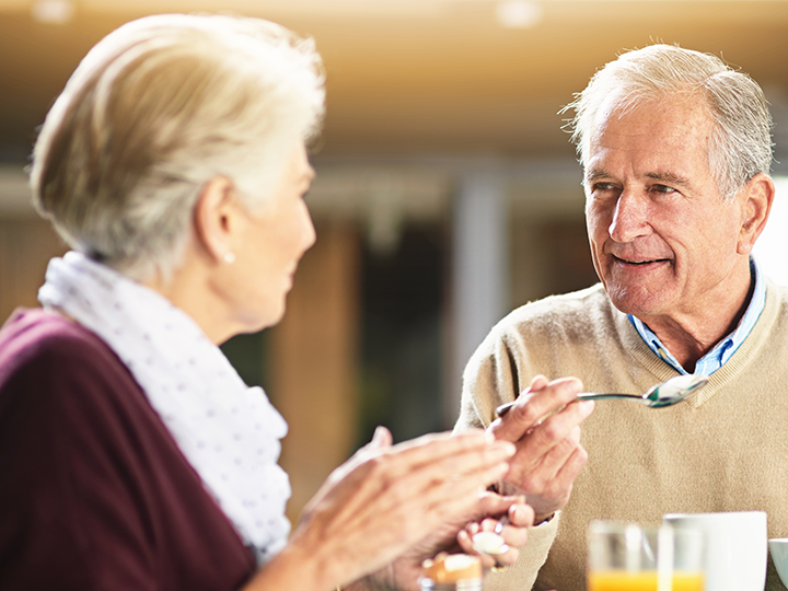 old man with and old woman eating and drinking something