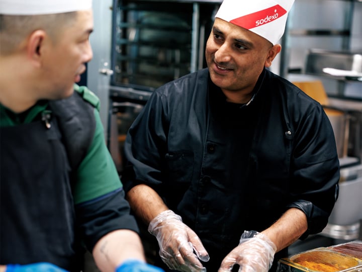 a happy chef looking to another