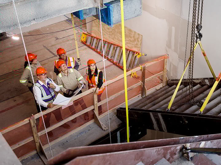 FM Construction workers inspecting a stairway being built