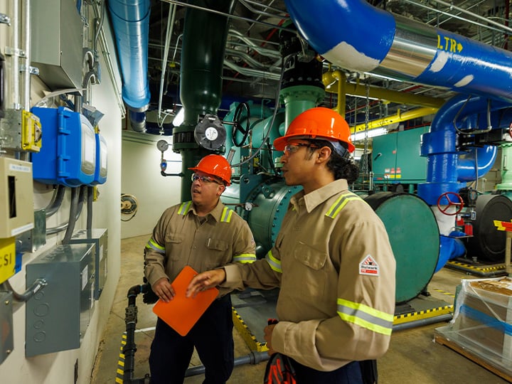 FM workers inspecting breaker panel of corporate building