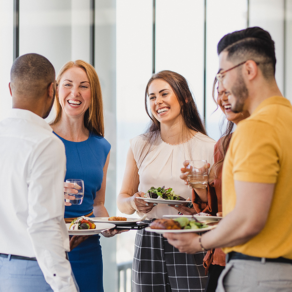 young of people standing sharing food