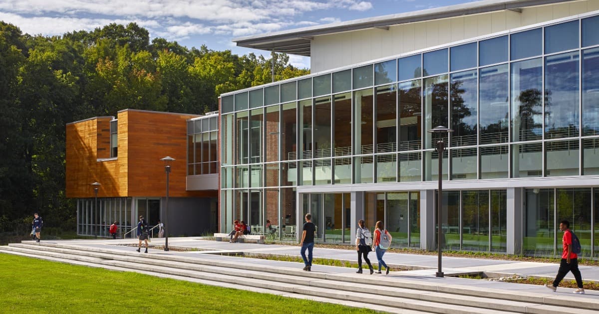 Exterior view of Virginia Wesleyan University’s Greer Environmental Sciences Center with students walking in front.