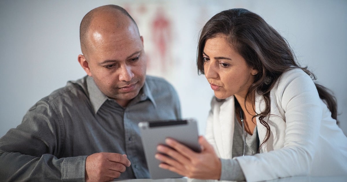 Registered dietitian and patient reviewing a nutrition plan together on a tablet. 