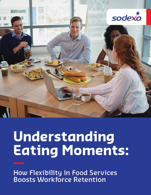 People gathered around a table in an office, enjoying a meal with salads, sandwiches, and drinks. The image includes the 'Sodexo' logo and a text overlay about food service flexibility.