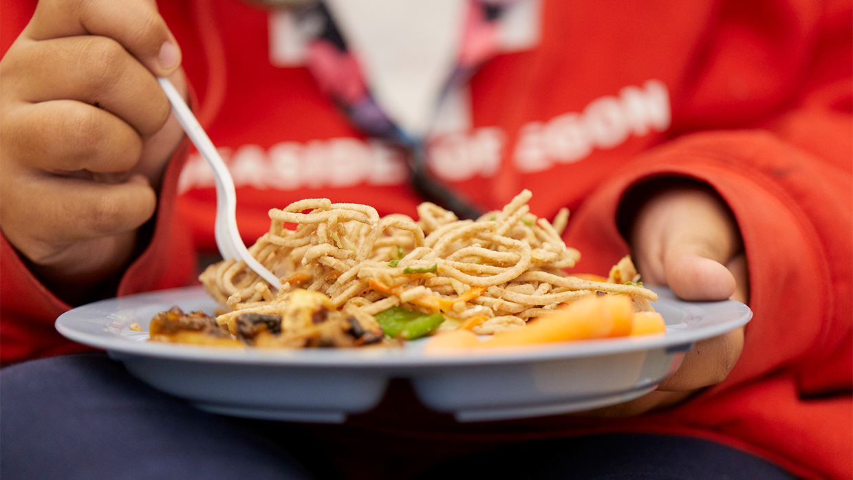 student-eating-noodle-dish