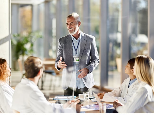 Presenter speaking to a group during a professional workshop or training session.