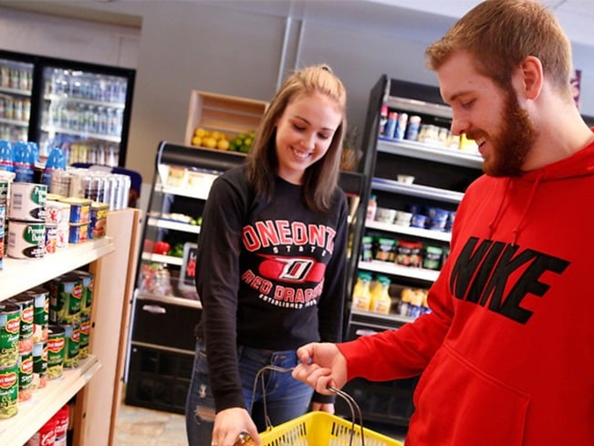 Two Oneonta students shopping in Mills Marketplace, a campus convenience store.  