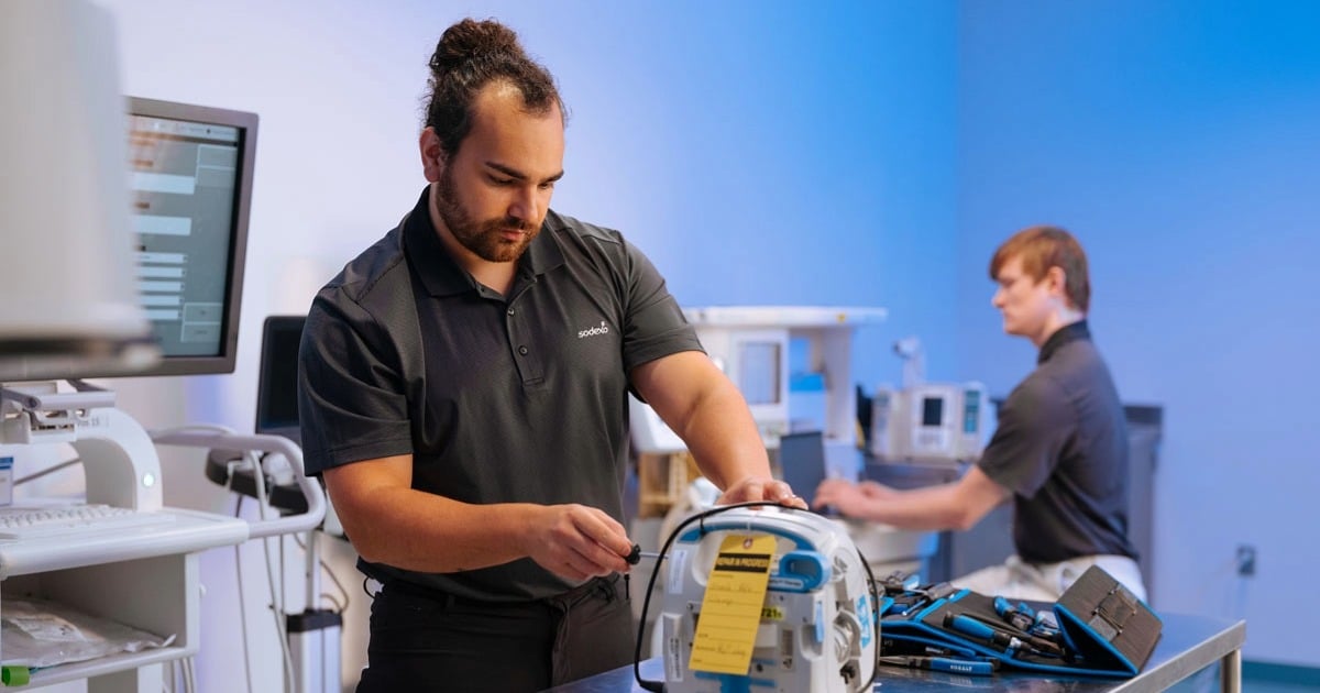 HTM professionals servicing medical equipment, representing the technical expertise that supports modern healthcare technology.