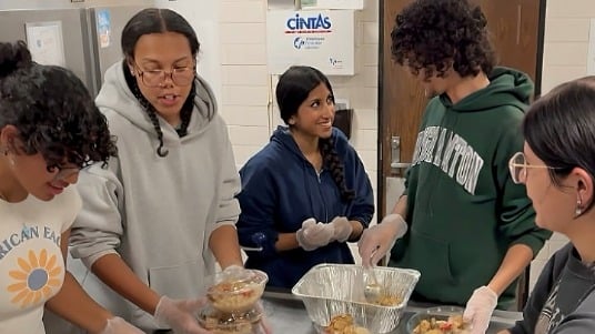 Students in Binghamton University’s Food Recovery Network prepare meals for donation in a campus kitchen.
