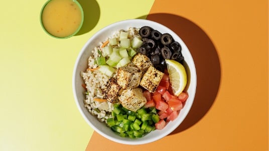 Grain bowl with lemon-pepper tofu and fresh diced vegetables.
