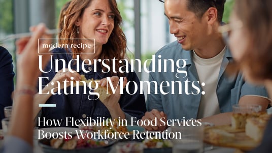 Workplace dining scene with colleagues sharing a meal, illustrating flexible food service and retention.