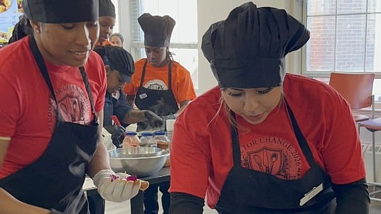 Delaware State University students engaging in hands-on cooking at the annual Cook for Change Cookoff event.