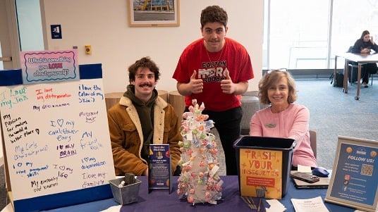 Students and the university dietitian at an activity booth during National Eating Disorders Awareness Week at Moravian University.