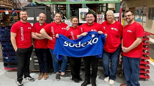 Sodexo employees posing for a group photo at a Stop Hunger volunteer event.