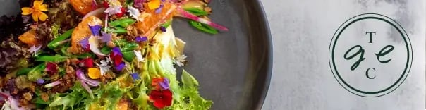 Plate of food with salad and nutritive food with the The good eating company logo.