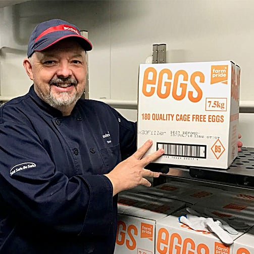 chef-holding-cage-free-eggs-in-kitchen