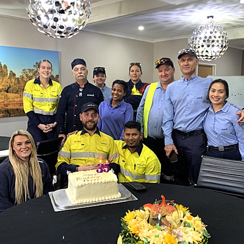 peter-brass-with-his-team-have-birthday-cake