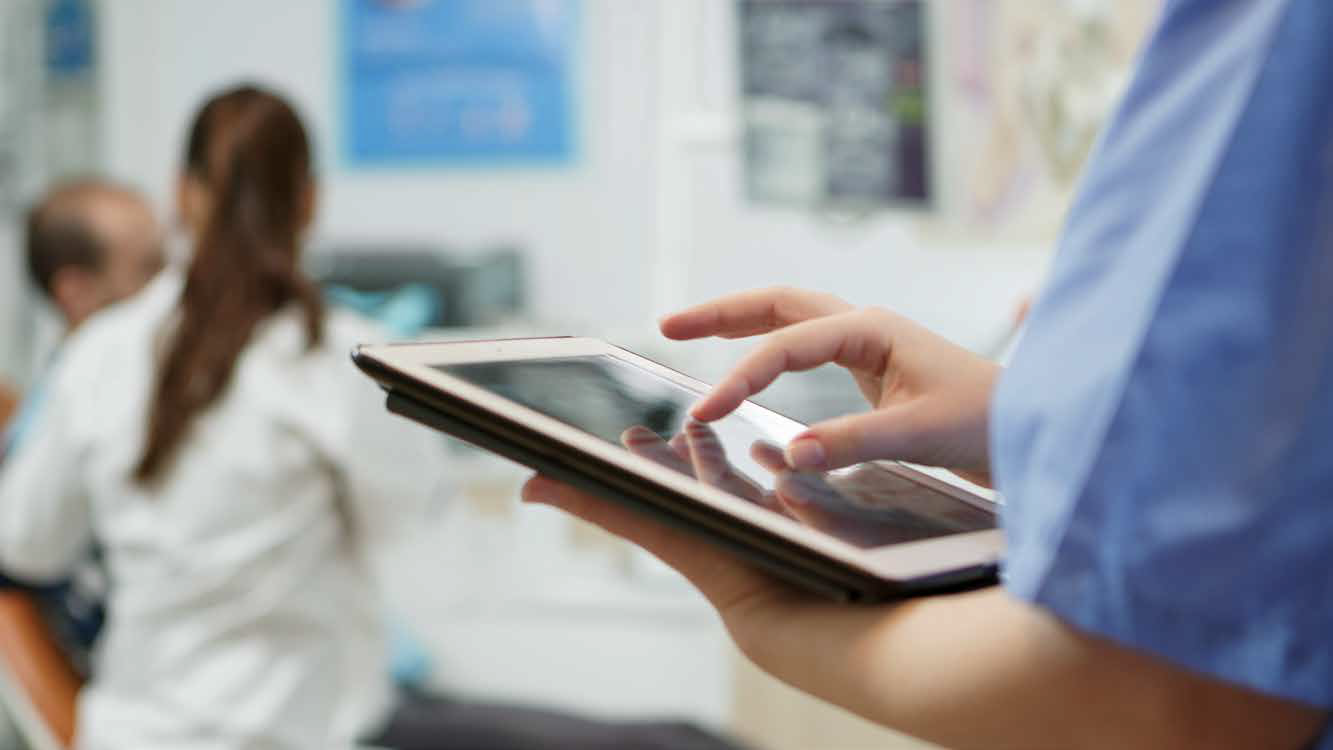 A doctor uses a tablet, highlighting technology in healthcare