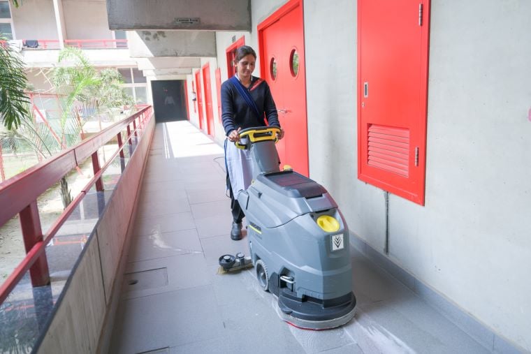 A woman operates a cleaning machine