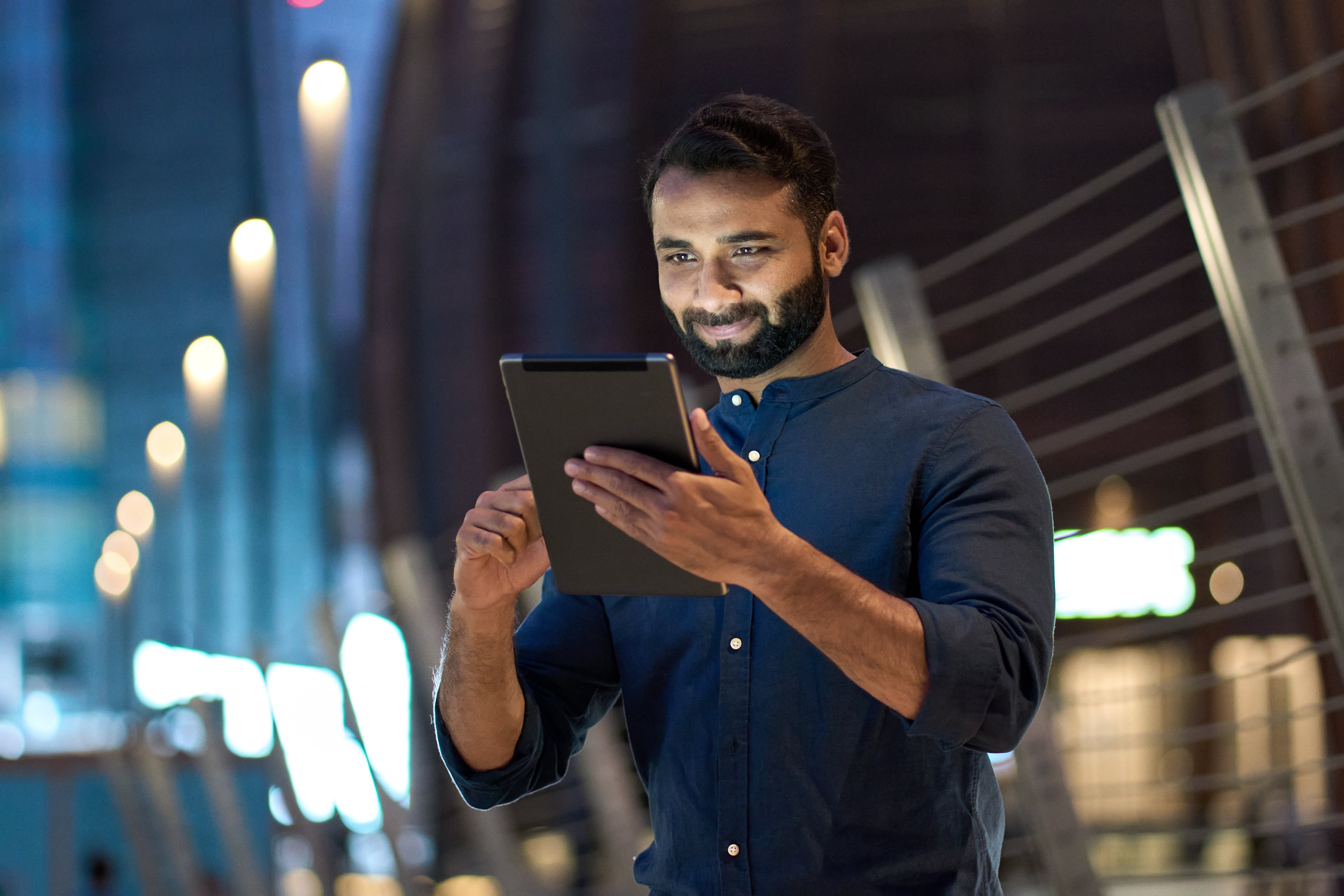 A man holding a tablet in his hands.