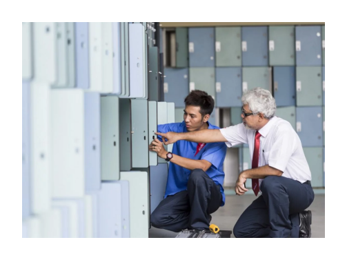 Two employees in Sodexo uniforms conducting a locker inspection.