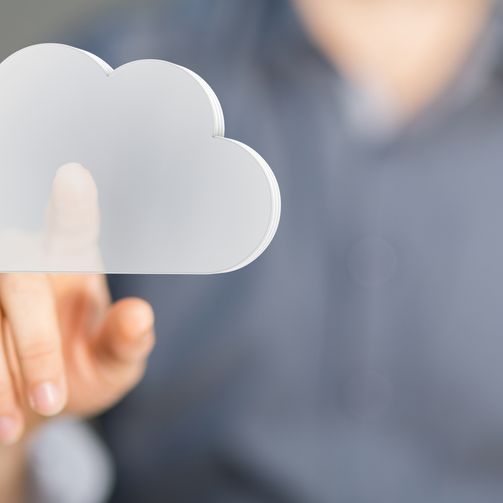 A man showcases a cloud icon, representing technology