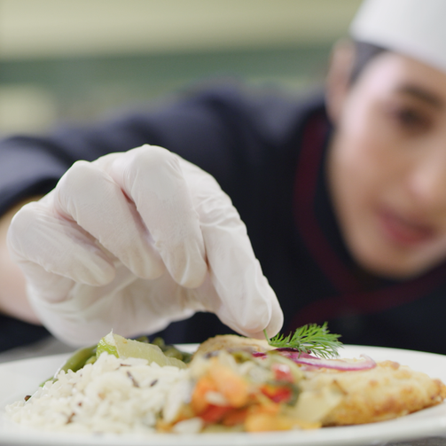 A chef plates a delicious meal