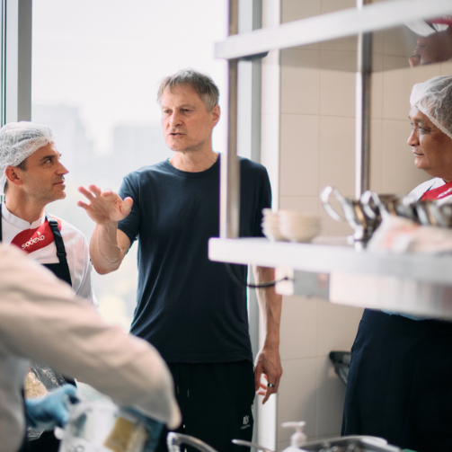 Chef Meyer giving instructions in a kitchen to Sodexo Chefs