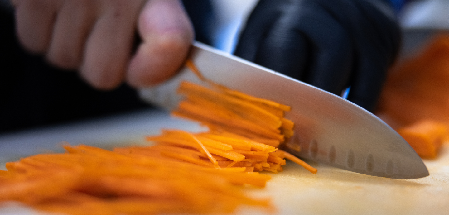 Carrots being cut julienne style