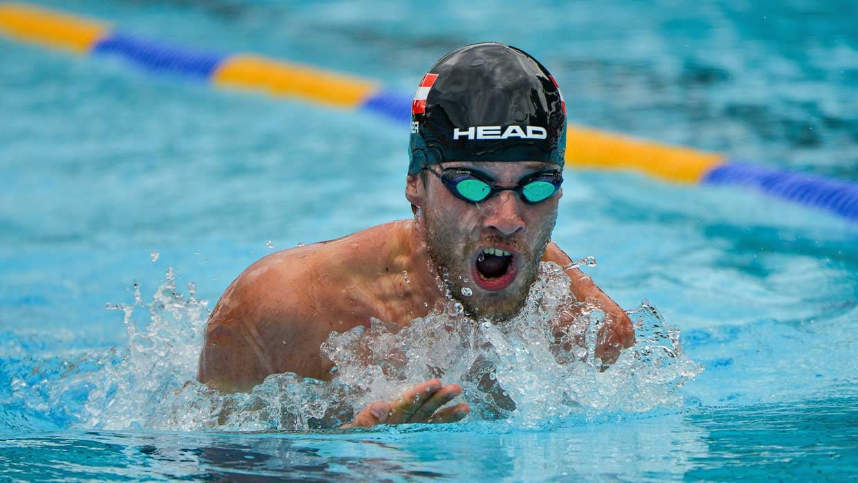 Schwimmer in Sportbecken mit Schwimmbrille und Schwimmhaube