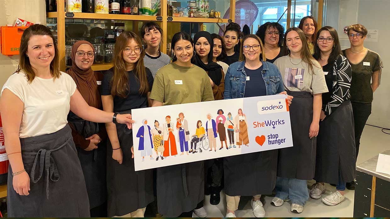 Diverse glueckliche Frauen unterschiedlichen Alters am Arbeitsplatz vereint zu Initiative She Works