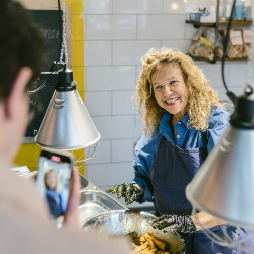 Haya Molcho wird bei den Sodexo Kochtagen während der Vorbereitung der Speisen von einem der Gäste mit dem Handy gefilmt.