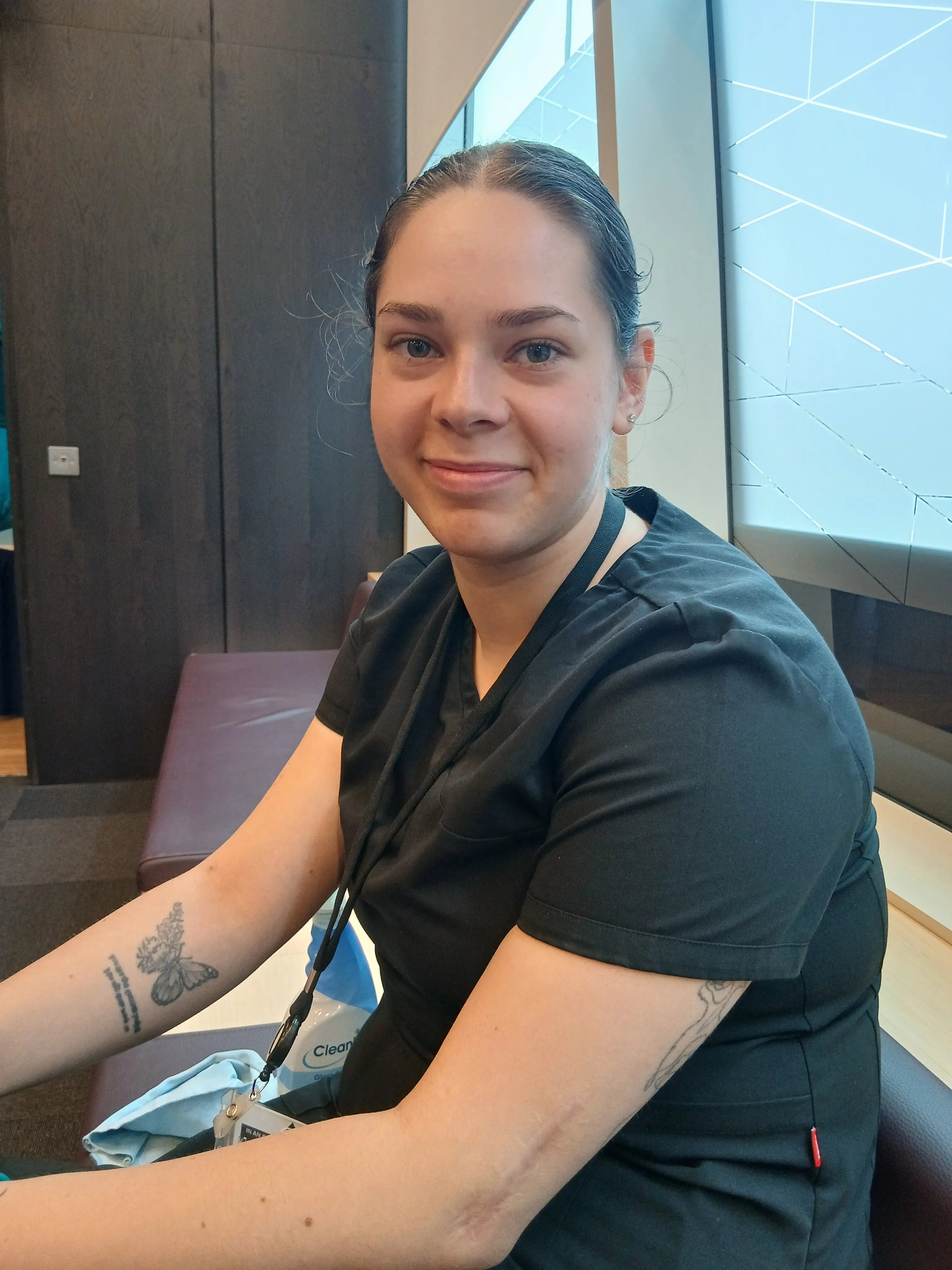 Portrait of a Sodexo colleague wearing a blue Sodexo polo shirt against a plain light-coloured background.