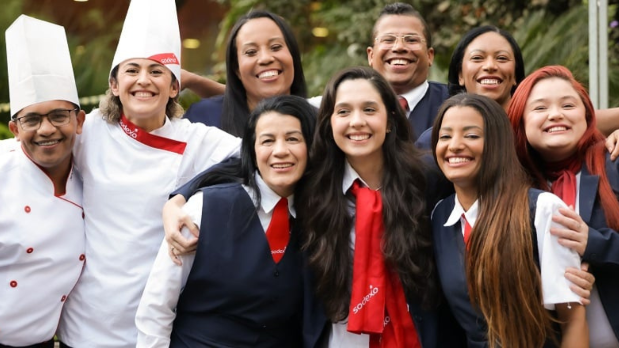 Team of happy Sodexo employees posing for a group photo